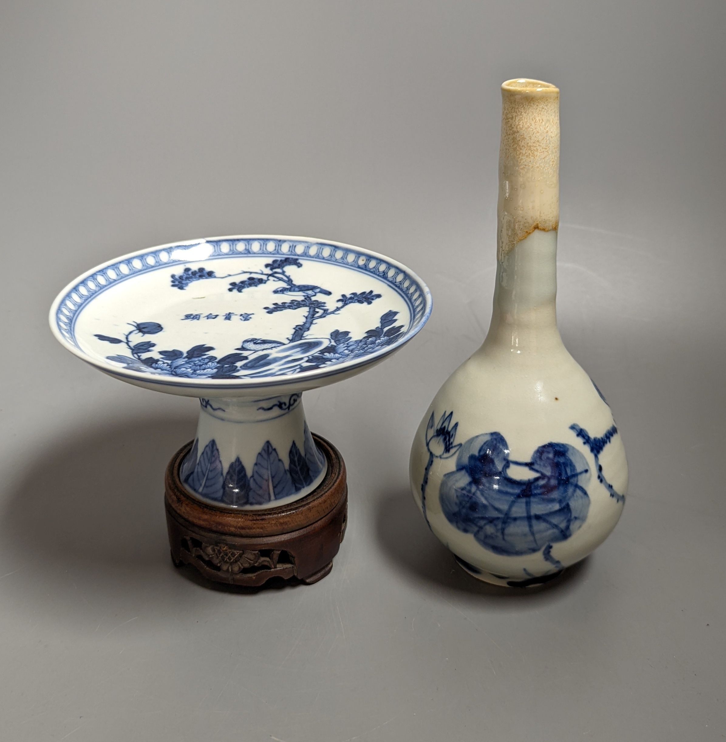 A 19th century Chinese blue and white stem dish, 14cm diameter and a Japanese or Korean art pottery bottle vase, 19cm (2)